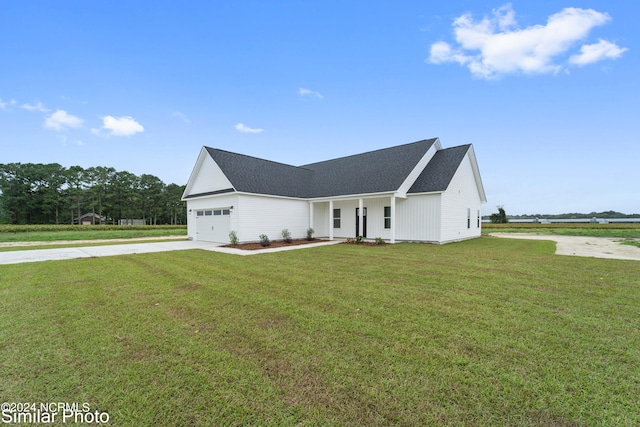 view of front facade with a front yard and a garage