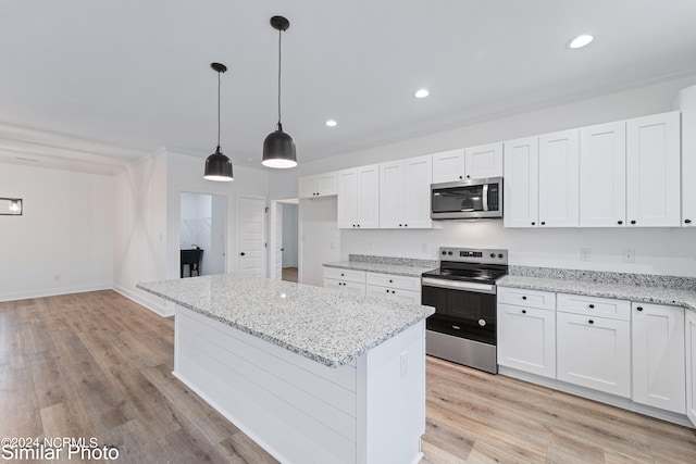 kitchen featuring appliances with stainless steel finishes, white cabinetry, light hardwood / wood-style flooring, and light stone counters