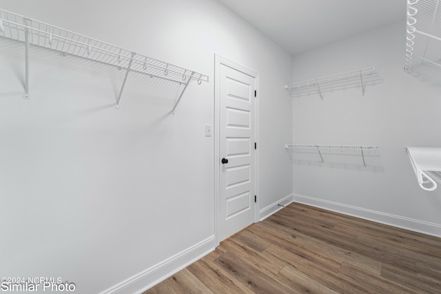 spacious closet featuring hardwood / wood-style floors