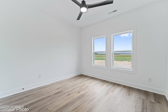 spare room with light hardwood / wood-style floors and ceiling fan