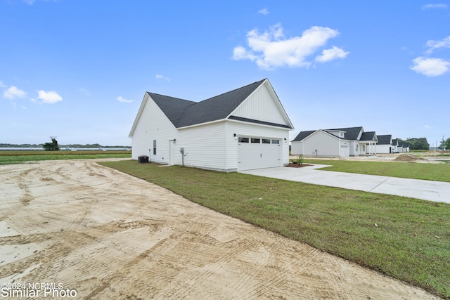 view of home's exterior featuring a lawn and a garage