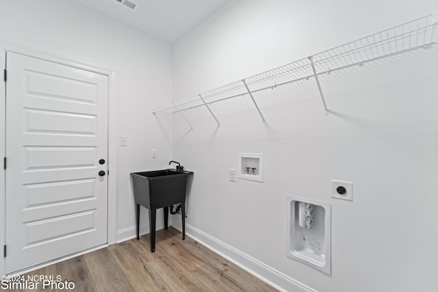 laundry room featuring hookup for an electric dryer, hardwood / wood-style floors, and washer hookup