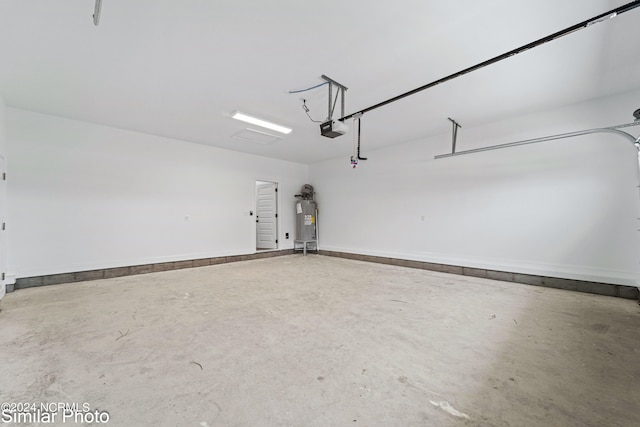 garage featuring a garage door opener and water heater