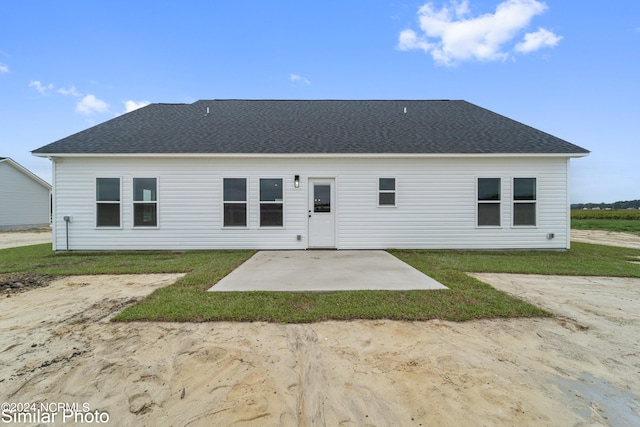 rear view of property with a lawn and a patio area