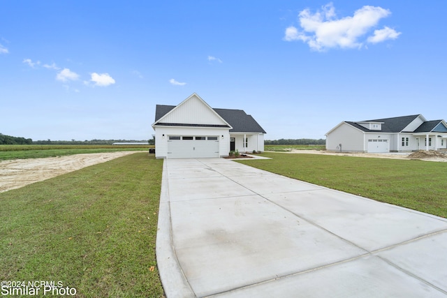 view of front facade with a front yard and a garage