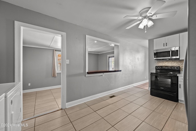 kitchen featuring backsplash, ceiling fan, independent washer and dryer, black / electric stove, and white cabinetry