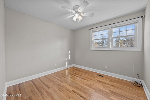 spare room featuring light hardwood / wood-style flooring and ceiling fan