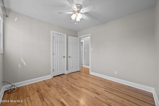 unfurnished bedroom with ceiling fan and light hardwood / wood-style flooring