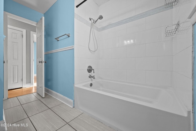 bathroom featuring tile patterned floors and tiled shower / bath