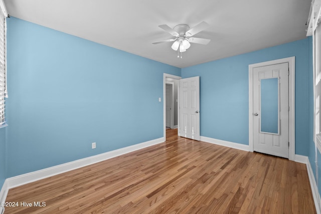 unfurnished bedroom with ceiling fan and light wood-type flooring