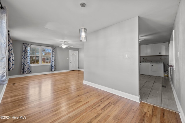 unfurnished living room with ceiling fan, light hardwood / wood-style floors, and independent washer and dryer