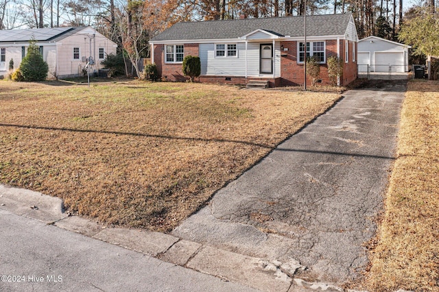 single story home with an outbuilding, a front lawn, and a garage