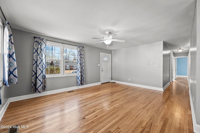 spare room with ceiling fan and light wood-type flooring