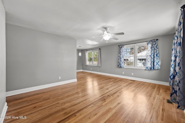 empty room with light hardwood / wood-style floors and ceiling fan