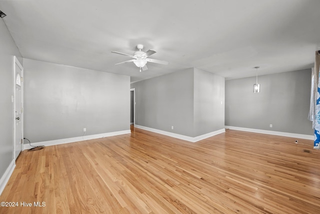 empty room with ceiling fan and light wood-type flooring