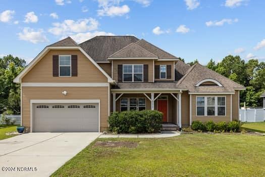 view of front facade featuring a front lawn and a garage