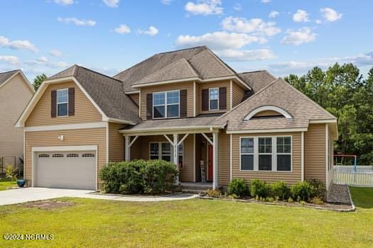 view of front of property featuring a front yard and a garage