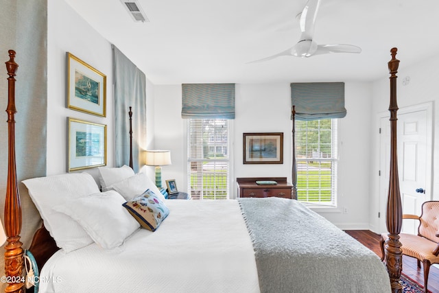 bedroom with ceiling fan, hardwood / wood-style floors, and multiple windows