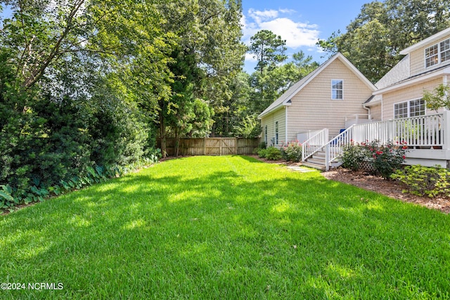 view of yard featuring a wooden deck