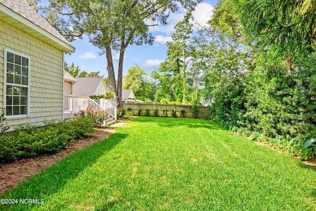 view of yard with a wooden deck