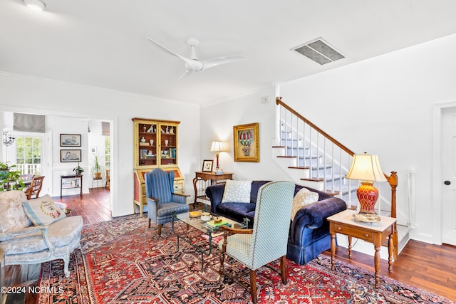 living room featuring crown molding, ceiling fan, and wood-type flooring