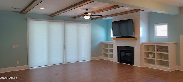 unfurnished living room with ceiling fan, wood-type flooring, and beamed ceiling