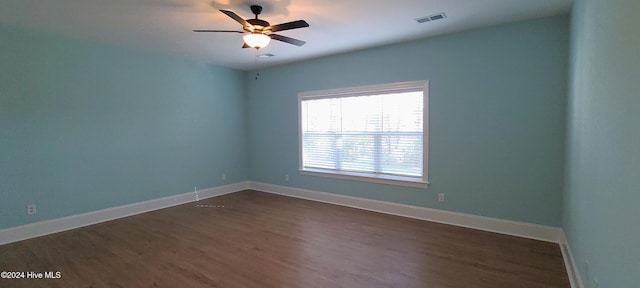 spare room featuring ceiling fan and dark hardwood / wood-style flooring