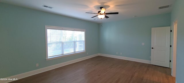 unfurnished room featuring dark hardwood / wood-style flooring and ceiling fan