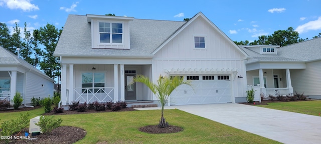 view of front facade with a porch, a garage, and a front yard