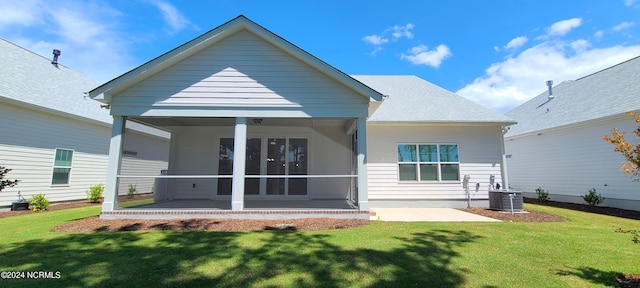 back of house with a sunroom, central air condition unit, a patio area, and a lawn