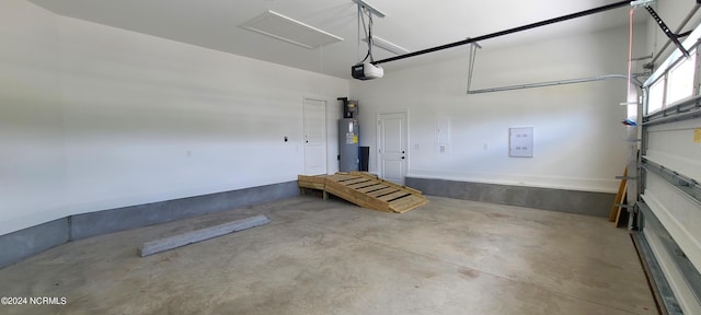 garage with a garage door opener and water heater