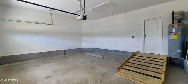 garage featuring a garage door opener and electric water heater