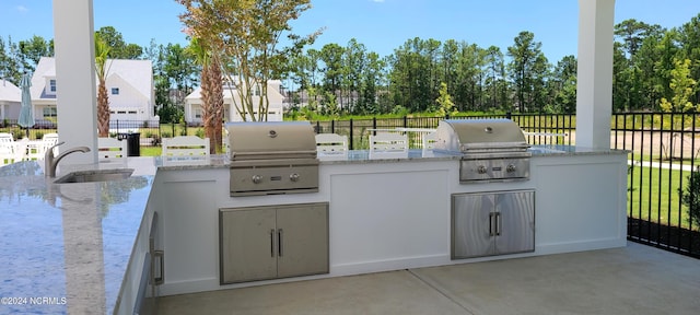 view of patio with area for grilling, grilling area, and sink