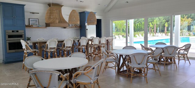 dining area featuring lofted ceiling with beams