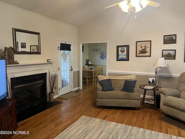 living room with wood-type flooring, ceiling fan, and vaulted ceiling