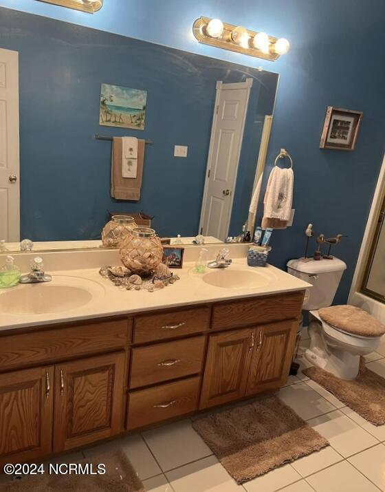 bathroom featuring vanity, tile patterned floors, and toilet