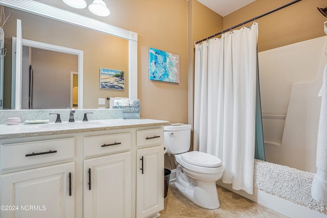 bathroom featuring tile patterned floors, vanity, and toilet