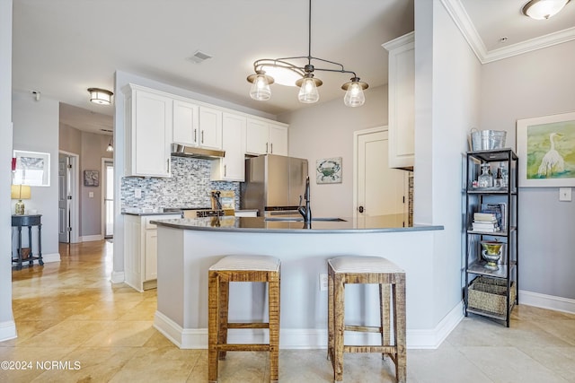 kitchen featuring stainless steel fridge, crown molding, decorative light fixtures, decorative backsplash, and white cabinets