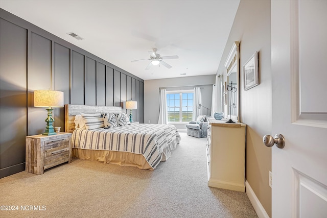 bedroom with ceiling fan and light colored carpet