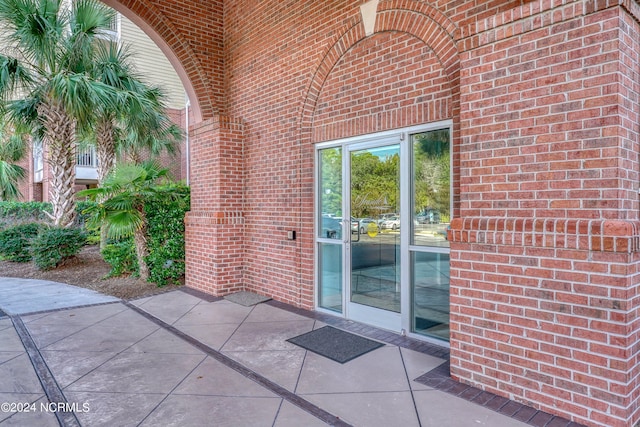 entrance to property featuring a patio area