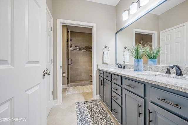 bathroom with tile patterned flooring, vanity, and a shower with shower door