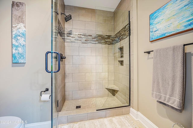 bathroom with toilet and an enclosed shower