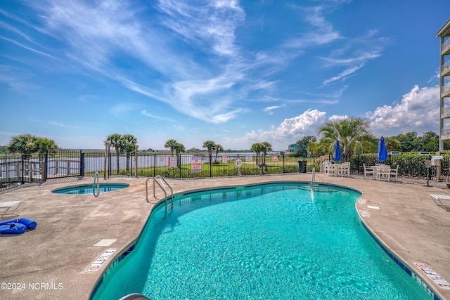 view of pool featuring a community hot tub and a patio