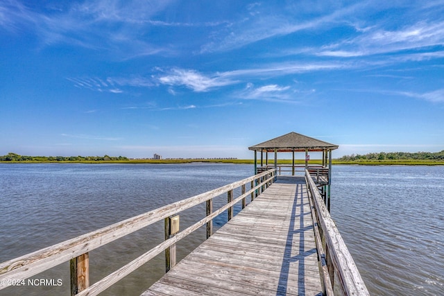 view of dock featuring a gazebo and a water view