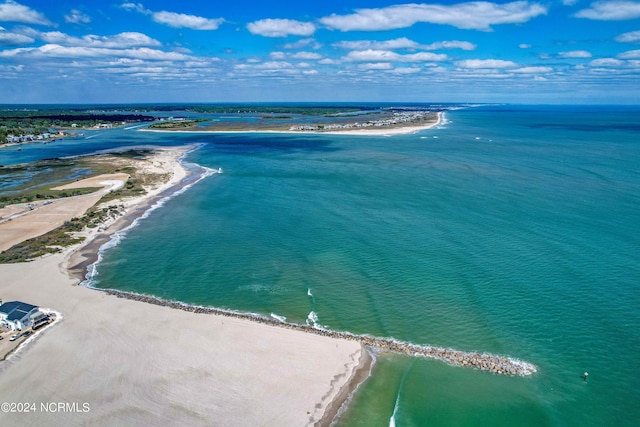 drone / aerial view featuring a water view and a beach view