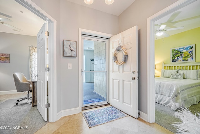 foyer featuring light colored carpet and ceiling fan