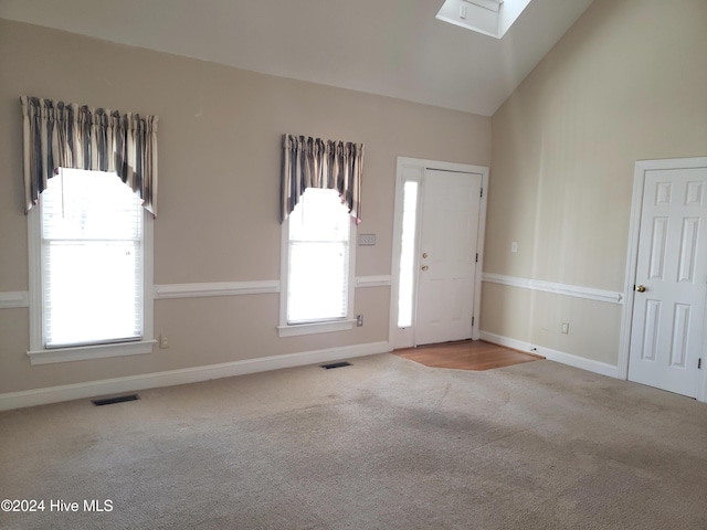 interior space featuring vaulted ceiling with skylight