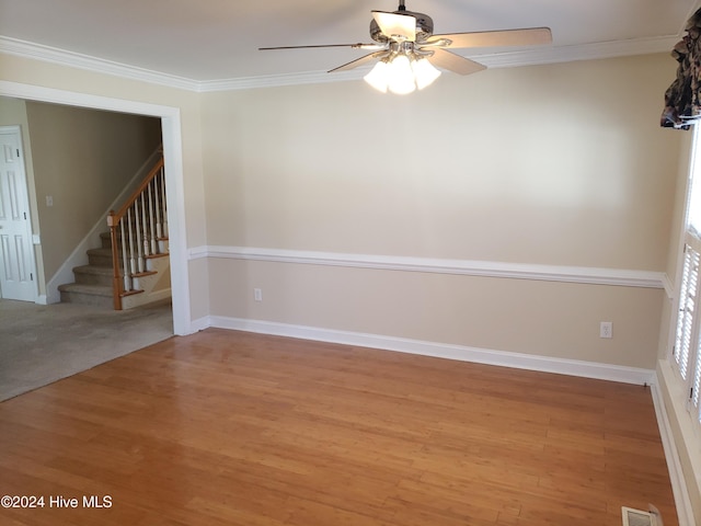 unfurnished room featuring ceiling fan, crown molding, and light hardwood / wood-style flooring