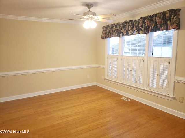 empty room featuring hardwood / wood-style floors, ceiling fan, and crown molding