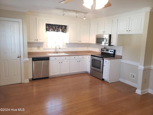 kitchen featuring sink, ceiling fan, light wood-type flooring, appliances with stainless steel finishes, and white cabinetry